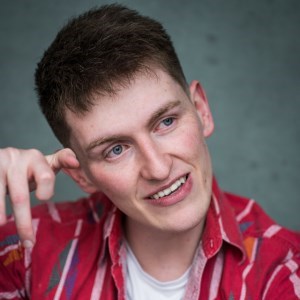 A caucasian man with brown hair and blue eyes