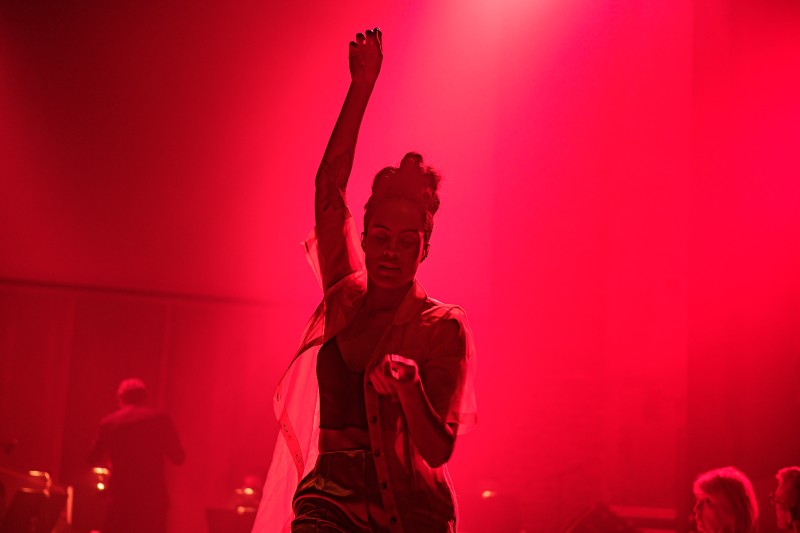 Alexandrina Hemsley in silhouette against a red coloured background