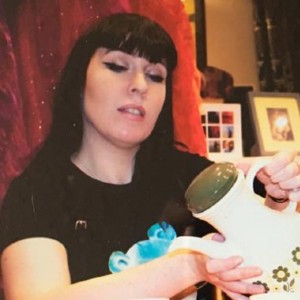 Clare McNulty pours tea from a teapot 